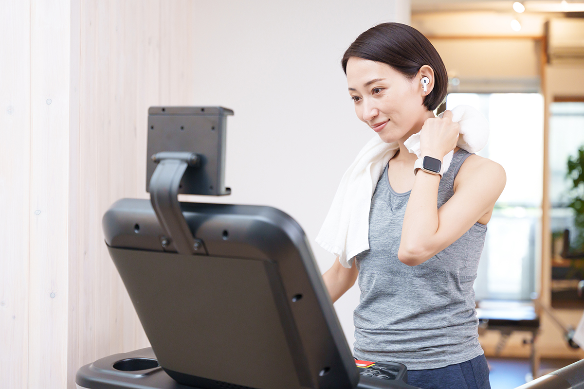 Woman exercising on a treadmill for fracture prevention. 