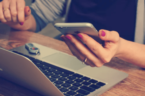 How to stay focused: A woman being distracted by her phone.