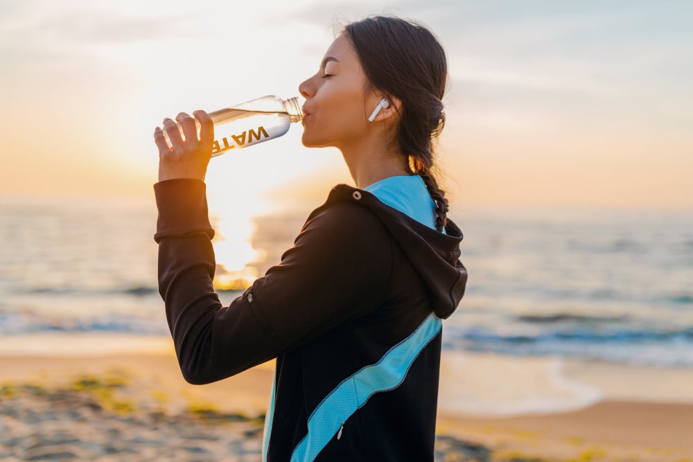 woman hydrating for bone health and fracture prevention