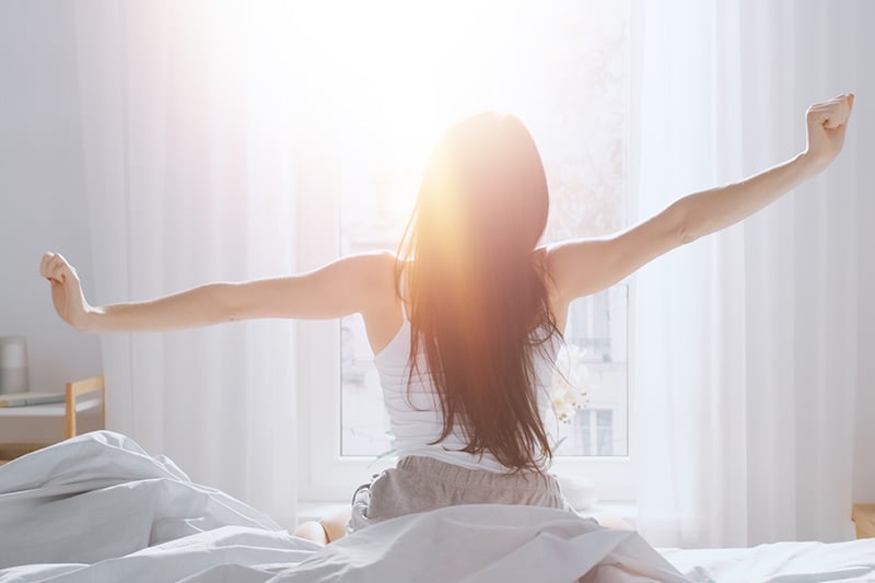 A woman waking up well-rested