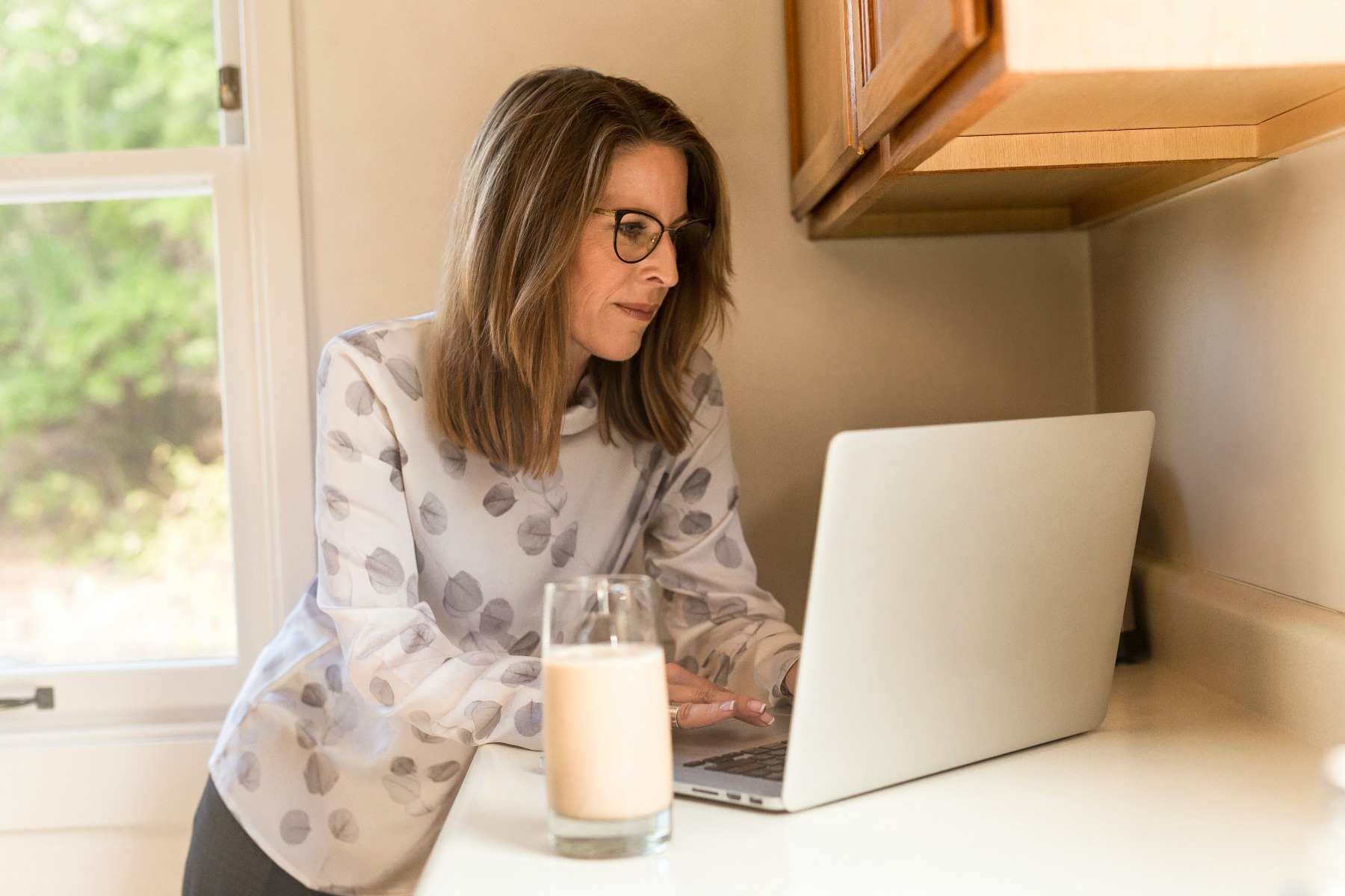 Build Healthy Bones: Woman working while drinking milk