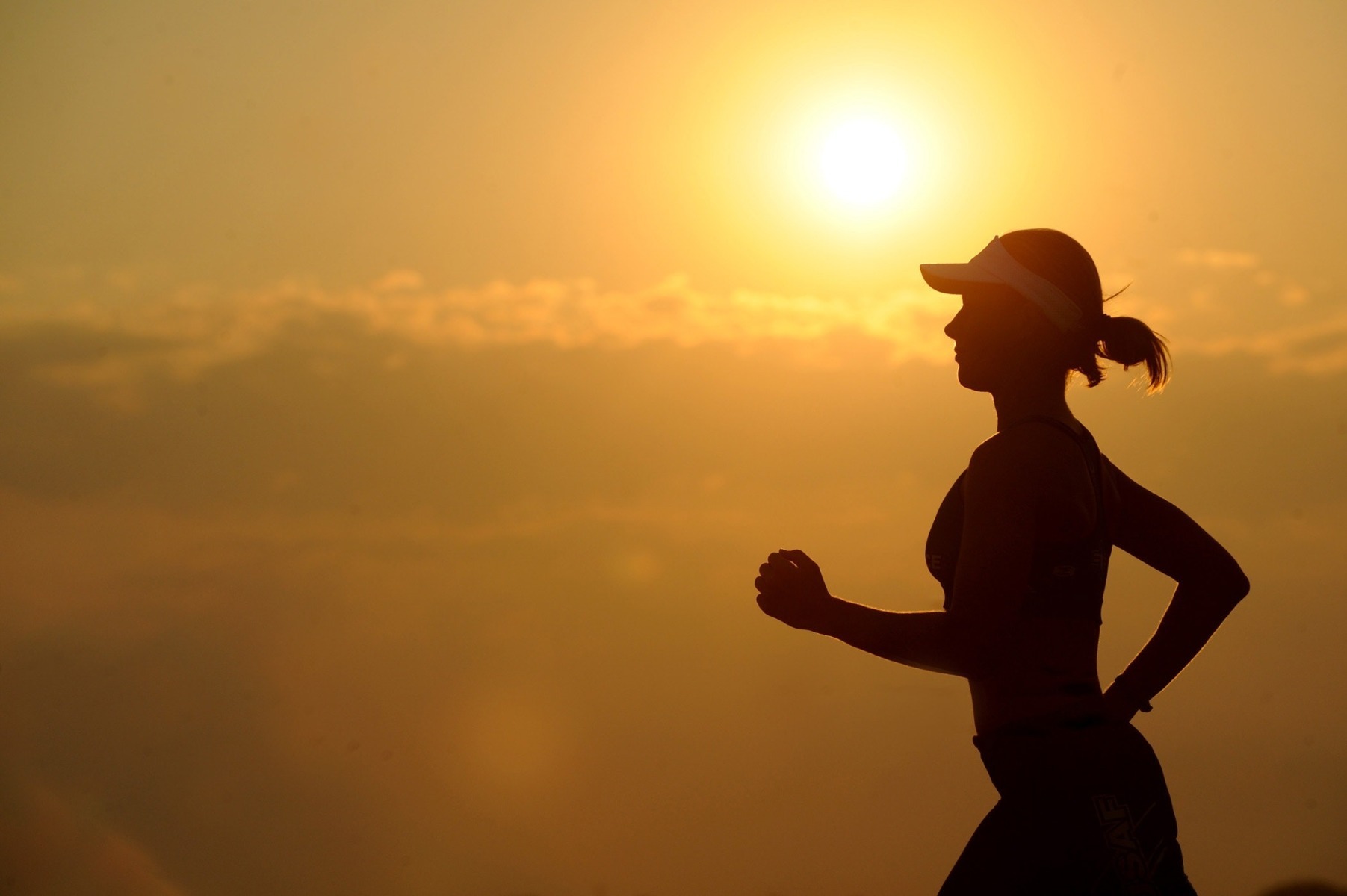 Ways to Destress: Woman doing exercise shown in silhouette