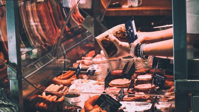 Foods to avoid with high cholesterol: a variety of red meat at a butcher shop