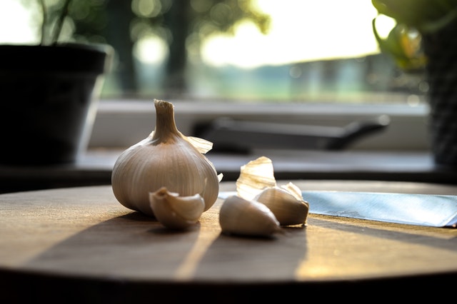 Garlic bulbs and cloves. Garlic may help to lower cholesterol